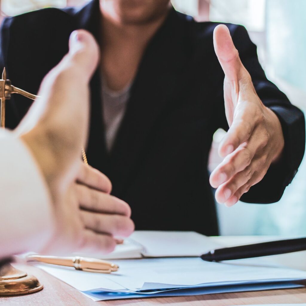 two hands outreached to shake