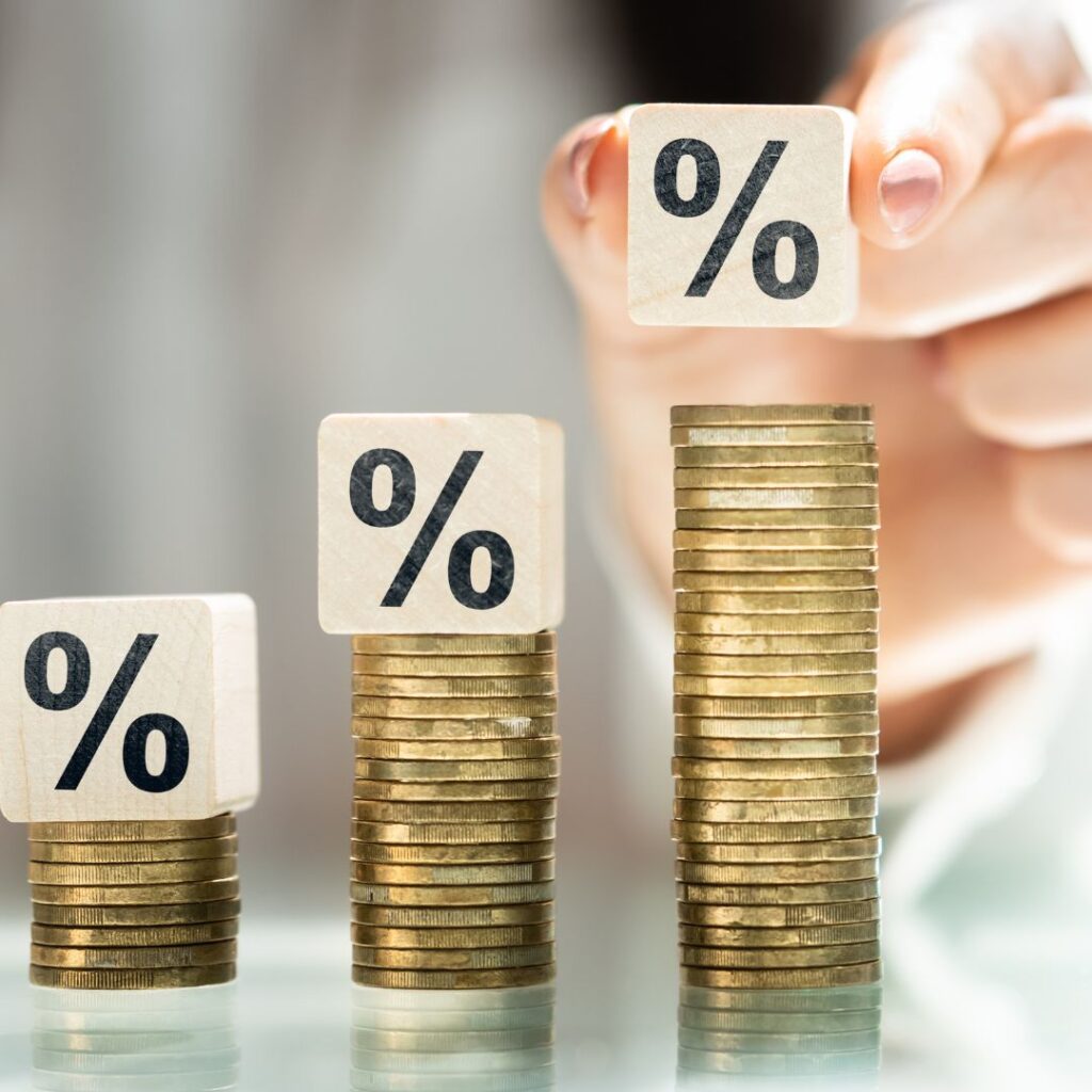 stacks of money with percentage blocks on top