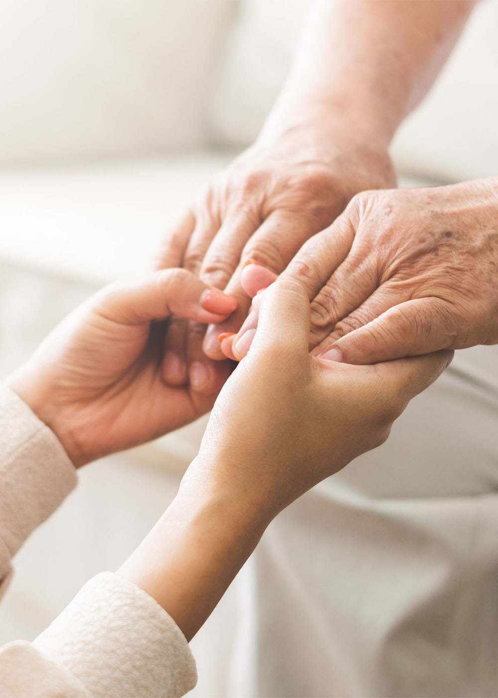 hands holding older person's hands