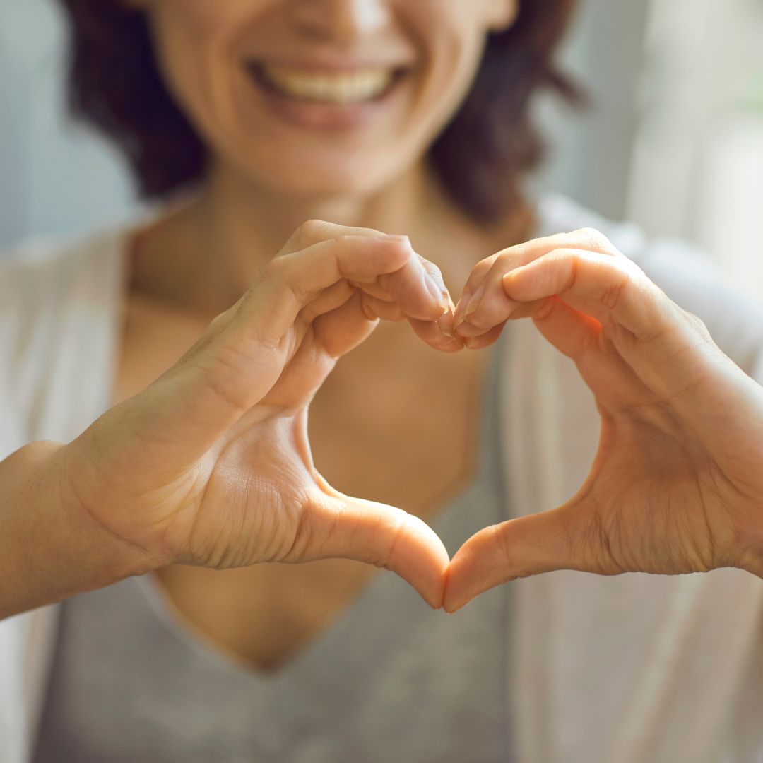 Woman making a heart shape with her hands