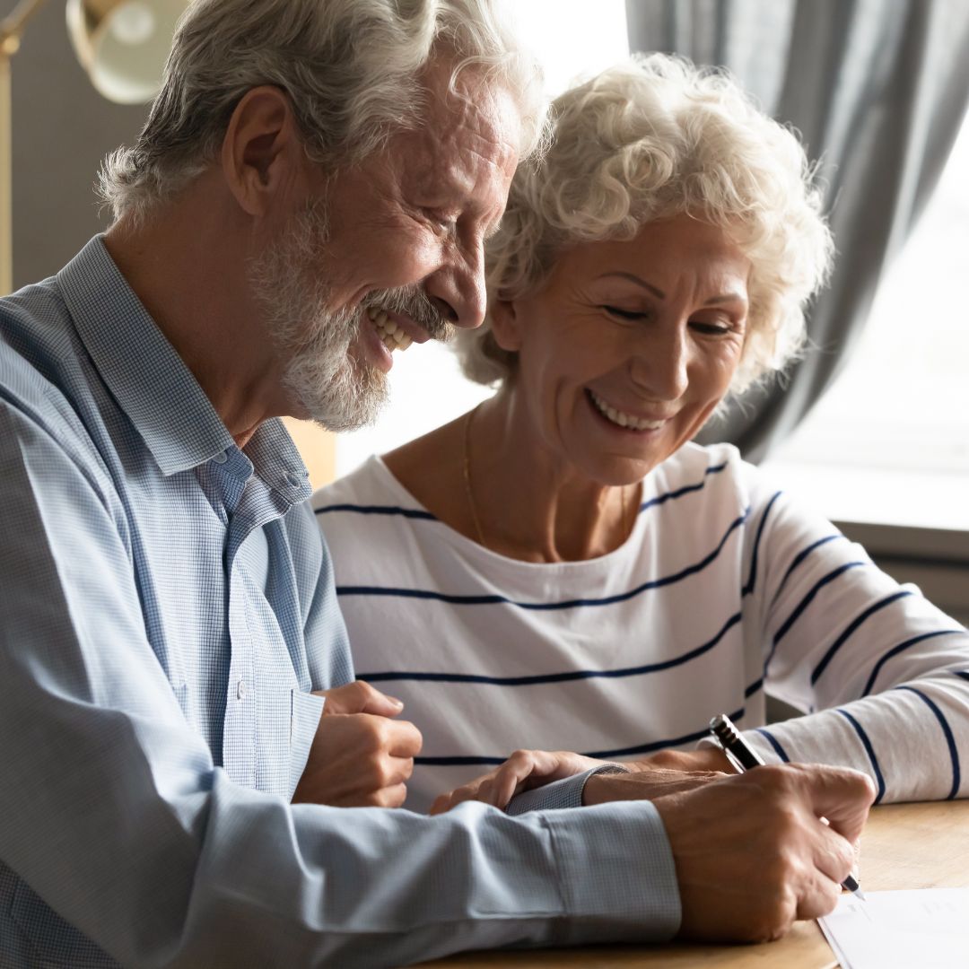 Two Seniors looking over paperwork