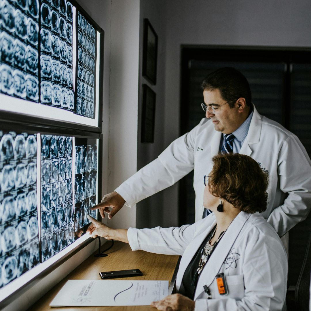 doctors reviewing scans on lighted wall