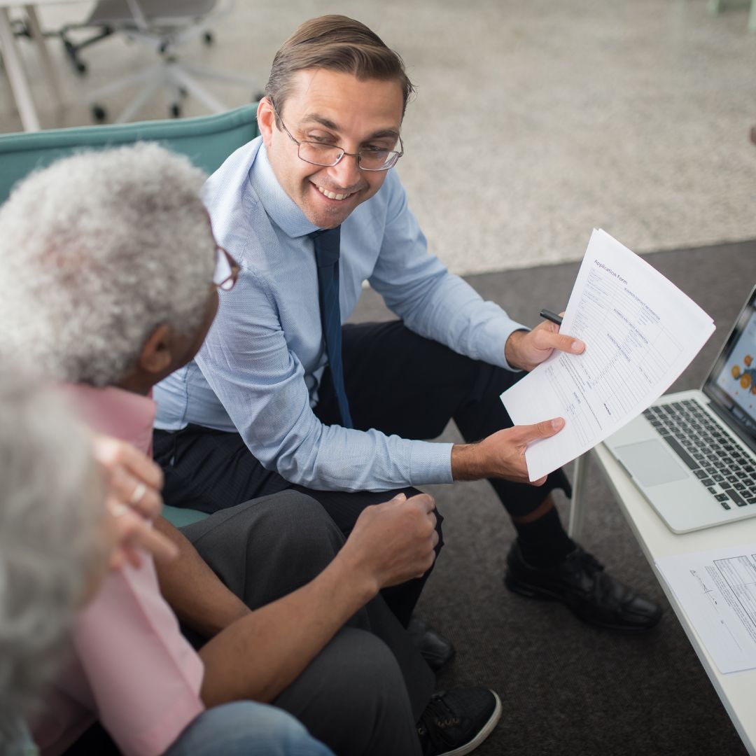 An insurance agent speaking with a client about settlements.
