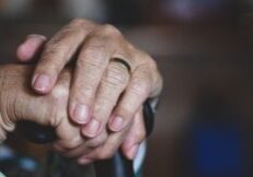 a person's hands holding a cane