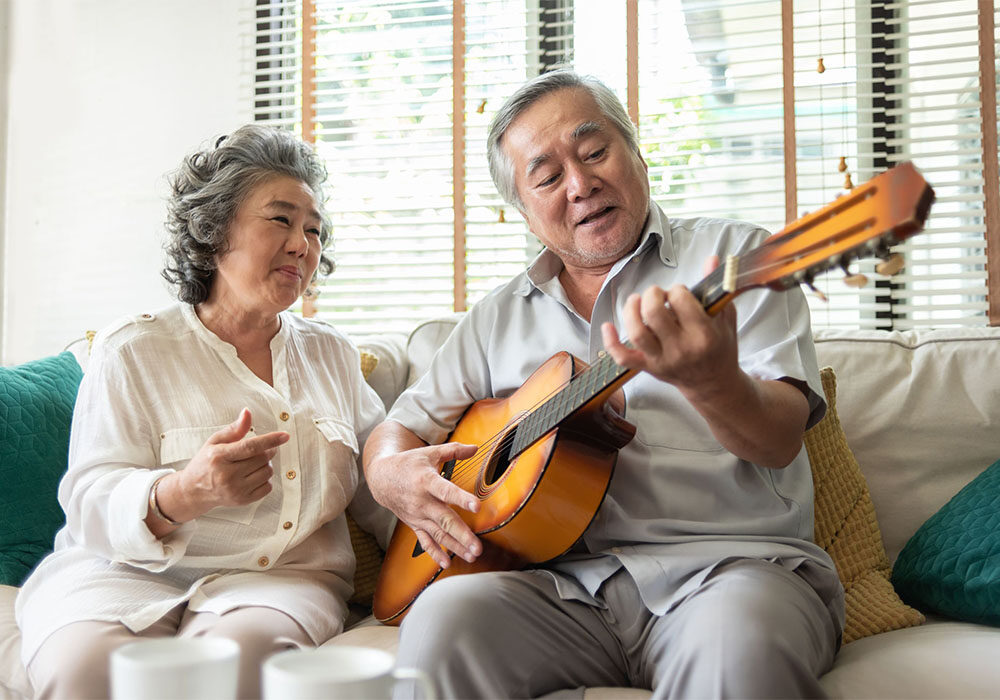 older couple playing guitar
