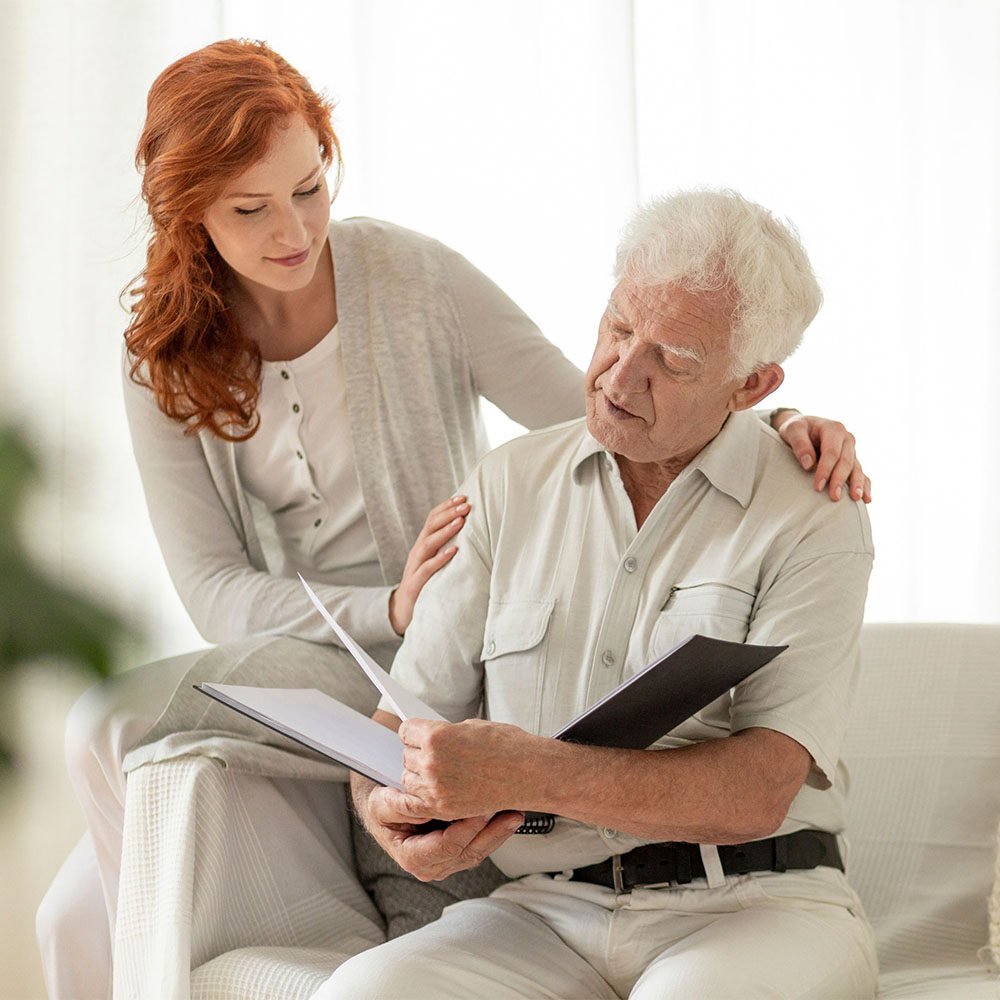 senior reviewing life settlement policy document with daughter