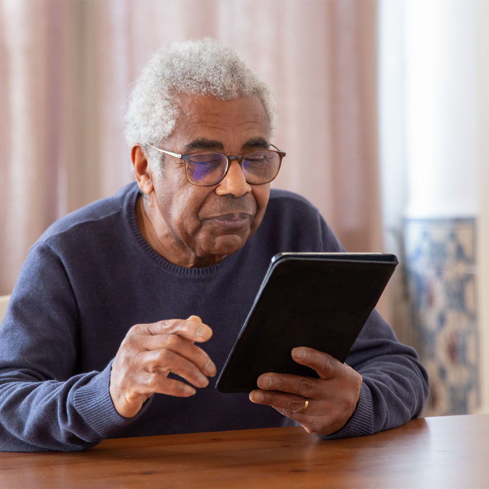 senior looking at tablet