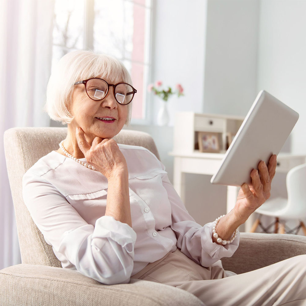 senior looking at tablet